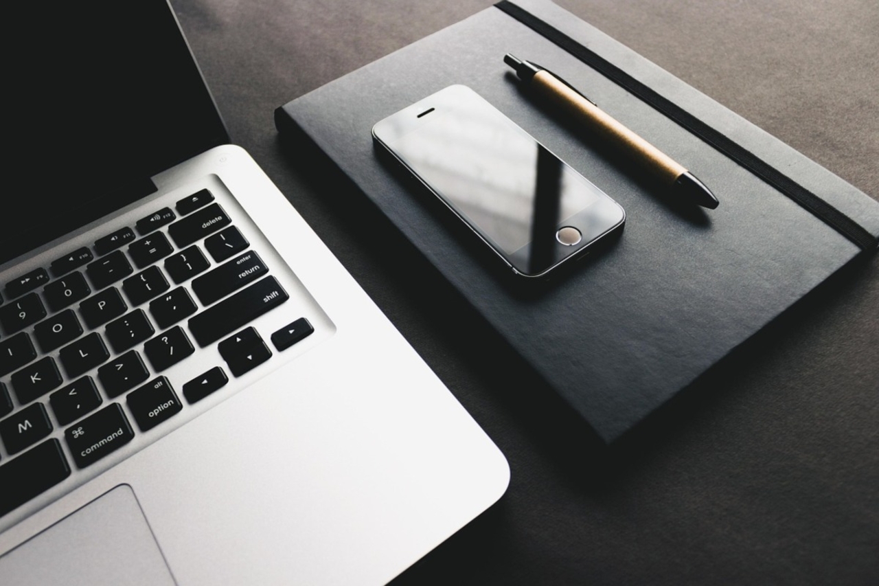 Laptop, phone, pen, notebook