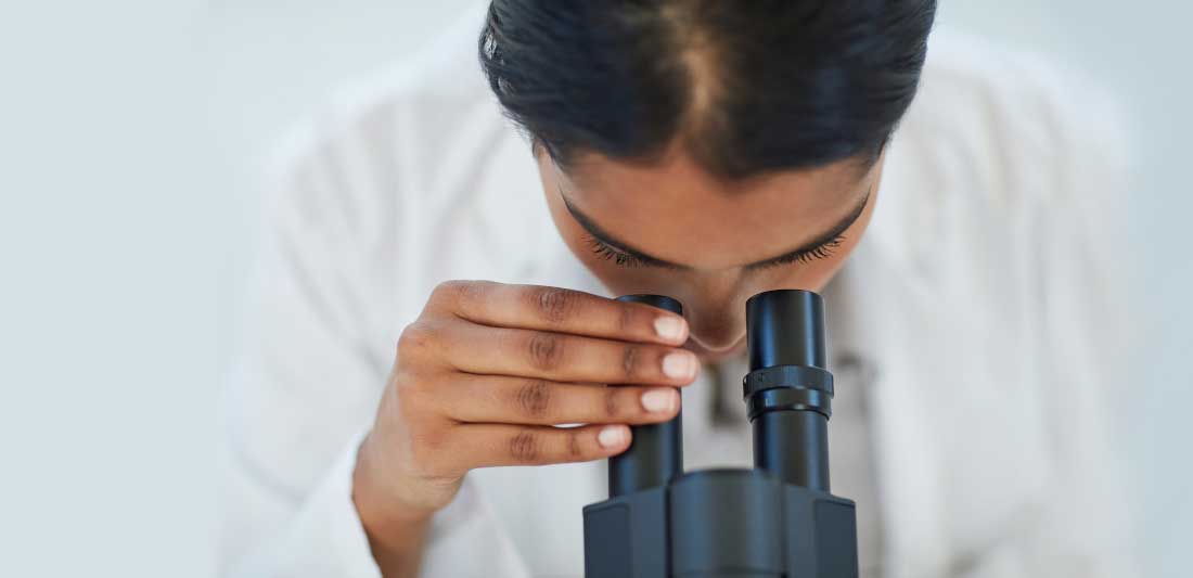 OpenScholar Homepage Banner - Scientist looking through microscope