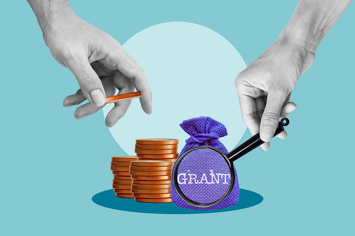 Concept of research funding with coins, magnifying glass, and hands on blue background